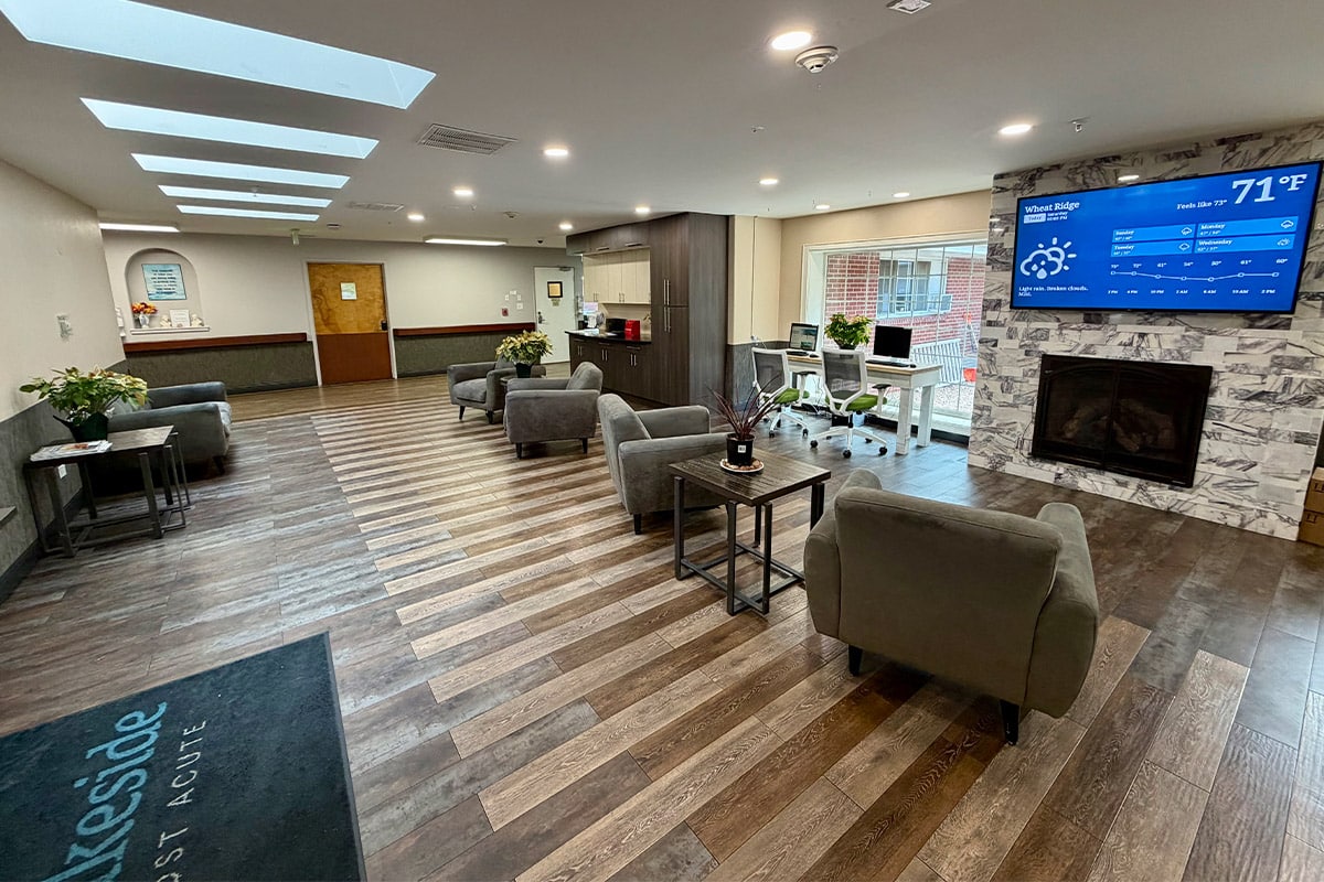 Seating with fireplace and TV in Lakeside Post Acute lobby